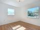Bright bedroom with hardwood floors and two windows at 611 S Montgomery Ave, Deland, FL 32720
