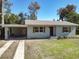 Inviting single-story home featuring a convenient carport and beautifully maintained landscaping at 611 S Montgomery Ave, Deland, FL 32720