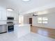 Open-concept kitchen with white cabinetry, stainless steel appliances, and kitchen island at 611 S Montgomery Ave, Deland, FL 32720