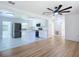 Bright, open kitchen with white cabinets, stainless steel appliances, and views to the living area at 611 S Montgomery Ave, Deland, FL 32720
