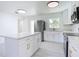 Bright kitchen featuring white cabinets, stainless steel appliances, and a center island at 611 S Montgomery Ave, Deland, FL 32720