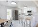 Contemporary kitchen featuring white cabinets, stainless steel appliances, and island with seating at 611 S Montgomery Ave, Deland, FL 32720