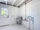 Laundry room featuring a utility sink, tiled floors, and a white exterior door at 611 S Montgomery Ave, Deland, FL 32720