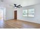 Bright living room featuring hardwood floors, a ceiling fan and a large window at 611 S Montgomery Ave, Deland, FL 32720