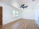 Minimalist living room with hardwood flooring and large window at 611 S Montgomery Ave, Deland, FL 32720