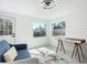 Bright living room featuring a modern ceiling fan, desk, and windows with backyard views at 611 S Montgomery Ave, Deland, FL 32720