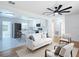 Bright living room with modern furniture, hardwood floors, and an open view to the kitchen at 611 S Montgomery Ave, Deland, FL 32720