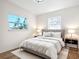 Stylishly furnished main bedroom featuring a comfortable bed, side tables and two windows at 611 S Montgomery Ave, Deland, FL 32720