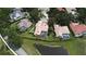 Aerial view of the property featuring a pool, screened patio, and lush green landscaping near a pond at 643 Cricklewood Ter, Lake Mary, FL 32746
