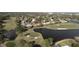 Aerial view of community homes near a golf course and a tranquil lake at 643 Cricklewood Ter, Lake Mary, FL 32746