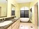 Bathroom featuring double sinks with granite countertops, a freestanding tub, and a walk-in shower at 643 Cricklewood Ter, Lake Mary, FL 32746