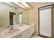 Bathroom features a large mirror, a double-sink vanity, and a door to the outside at 643 Cricklewood Ter, Lake Mary, FL 32746