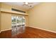 Bedroom featuring hardwood floors, large windows with pool views, and a ceiling fan at 643 Cricklewood Ter, Lake Mary, FL 32746