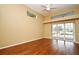 Bright bedroom with hardwood floors, a high ceiling, and large glass sliders leading to the pool area at 643 Cricklewood Ter, Lake Mary, FL 32746