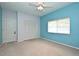 Blue bedroom with ample natural light, featuring a closet and ceiling fan for comfortable living at 643 Cricklewood Ter, Lake Mary, FL 32746