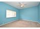 Bright blue bedroom featuring a window, carpet, and ceiling fan for comfortable living at 643 Cricklewood Ter, Lake Mary, FL 32746