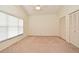 Neutral bedroom featuring large window, ceiling fan, and closet for ample storage at 643 Cricklewood Ter, Lake Mary, FL 32746