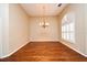Dining room with hardwood floors, chandelier, large windows, and neutral walls offering an elegant atmosphere at 643 Cricklewood Ter, Lake Mary, FL 32746
