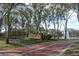 Welcoming brick entrance to the Heathrow community with lush landscaping and mature trees at 643 Cricklewood Ter, Lake Mary, FL 32746
