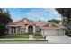 Charming single-story home featuring a three-car garage and well-manicured front lawn and double door entrance at 643 Cricklewood Ter, Lake Mary, FL 32746