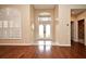 Inviting foyer featuring gleaming hardwood floors, double doors with transom window, and bright shutters at 643 Cricklewood Ter, Lake Mary, FL 32746