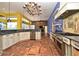 Unique chef's kitchen with brick floors, custom cabinets, professional appliances, and multi colored walls at 643 Cricklewood Ter, Lake Mary, FL 32746