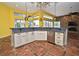 Kitchen with island, stainless steel appliances, and custom cabinets overlooking living room at 643 Cricklewood Ter, Lake Mary, FL 32746