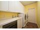 Bright laundry room with front-load washer and dryer, sink, and ample storage space in white cabinetry at 643 Cricklewood Ter, Lake Mary, FL 32746