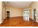 Open living room with hardwood floors, neutral walls, and sliding glass doors with views of the pool at 643 Cricklewood Ter, Lake Mary, FL 32746