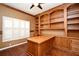 Bright office space offering a custom built-in desk, shelving units, and natural light from a window at 643 Cricklewood Ter, Lake Mary, FL 32746