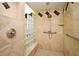 Beautiful tiled shower with glass block window, built-in seat, and grab bars for safety at 643 Cricklewood Ter, Lake Mary, FL 32746