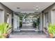 Building entrance featuring glass doors, a tiled walkway, and manicured landscaping at 1100 Delaney Ave # F407, Orlando, FL 32806