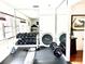 Mirrored gym featuring free weights, exercise equipment, and a sleek black floor at 1100 Delaney Ave # F407, Orlando, FL 32806