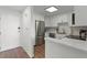 Bright modern kitchen featuring white cabinets, stainless steel appliances, and wood-look flooring at 1100 Delaney Ave # F407, Orlando, FL 32806
