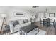 Cozy living room features wood floors, modern furniture, and abundant natural light at 1100 Delaney Ave # F407, Orlando, FL 32806