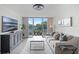 The bright living room features a walk-out balcony, natural light, and modern furnishings at 1100 Delaney Ave # F407, Orlando, FL 32806