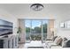 This modern and airy living room has a fantastic view from the balcony at 1100 Delaney Ave # F407, Orlando, FL 32806