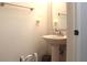 Well-lit half-bathroom with a pedestal sink, a mirror, and a convenient towel bar at 115 Willowbay Ridge St, Sanford, FL 32771