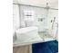 Modern bathroom featuring a stylish freestanding tub and a walk-in shower with marble surround at 115 Willowbay Ridge St, Sanford, FL 32771