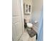 Cozy powder room featuring tiled floors, a wall cabinet, and a standard toilet at 115 Willowbay Ridge St, Sanford, FL 32771