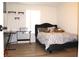 Bedroom featuring a modern bed frame, a desk, and neutral wall colors at 115 Willowbay Ridge St, Sanford, FL 32771