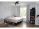 Bright bedroom featuring neutral walls, ceiling fan, and natural light from the large window at 115 Willowbay Ridge St, Sanford, FL 32771