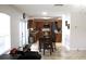 Open concept kitchen with dining table featuring wood cabinets, tile floors and stainless appliances at 115 Willowbay Ridge St, Sanford, FL 32771