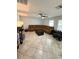 Spacious living room with tile floors, large sectional sofa, and a ceiling fan at 115 Willowbay Ridge St, Sanford, FL 32771