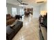 Living room with kitchen access featuring tile floors and a ceiling fan at 115 Willowbay Ridge St, Sanford, FL 32771