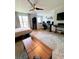 Open-concept living space with a ceiling fan, desk, and large rug providing a cozy, modern atmosphere at 115 Willowbay Ridge St, Sanford, FL 32771