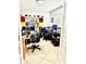 Bright home office featuring modern desks, ergonomic chairs, and ample storage shelving at 115 Willowbay Ridge St, Sanford, FL 32771