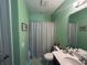 Well-lit bathroom with green walls, a shower-tub combination, and a neutral vanity at 1166 Heron Sound Dr, Apopka, FL 32703