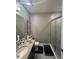 Modern bathroom featuring a sleek vanity, glass-enclosed shower, and contemporary fixtures at 1166 Heron Sound Dr, Apopka, FL 32703