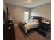 Inviting bedroom with a queen-sized bed, large window, and comfortable workspace at 1166 Heron Sound Dr, Apopka, FL 32703